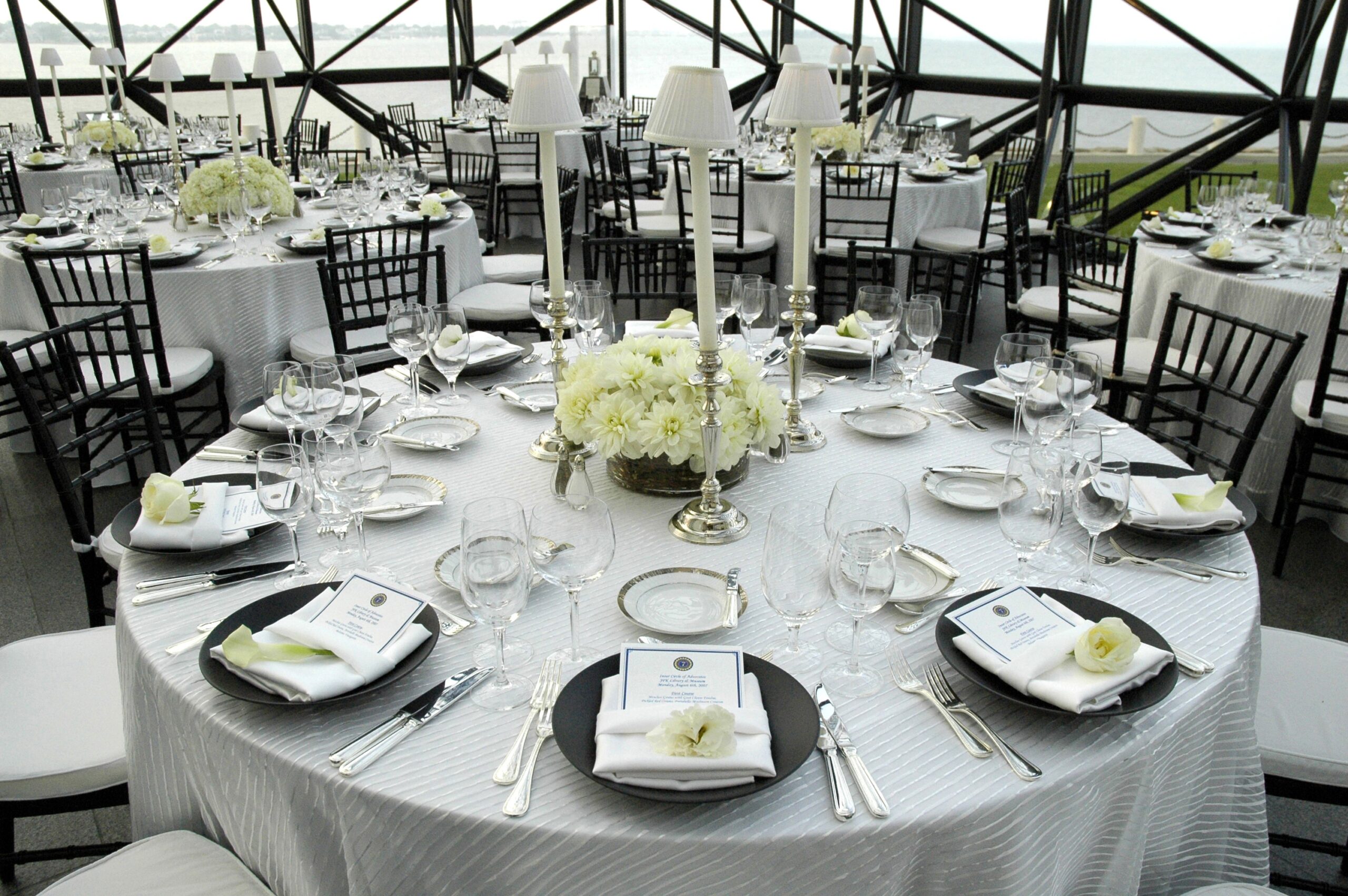 Corporate dinner table set with white florals and candlelight at a New York City event